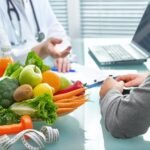 Nutritionist is consulting the patient about healthy diet with vegetables and fruits