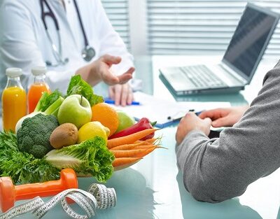 Nutritionist is consulting the patient about healthy diet with vegetables and fruits